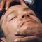 homme allonge se faisant examiner le visage
